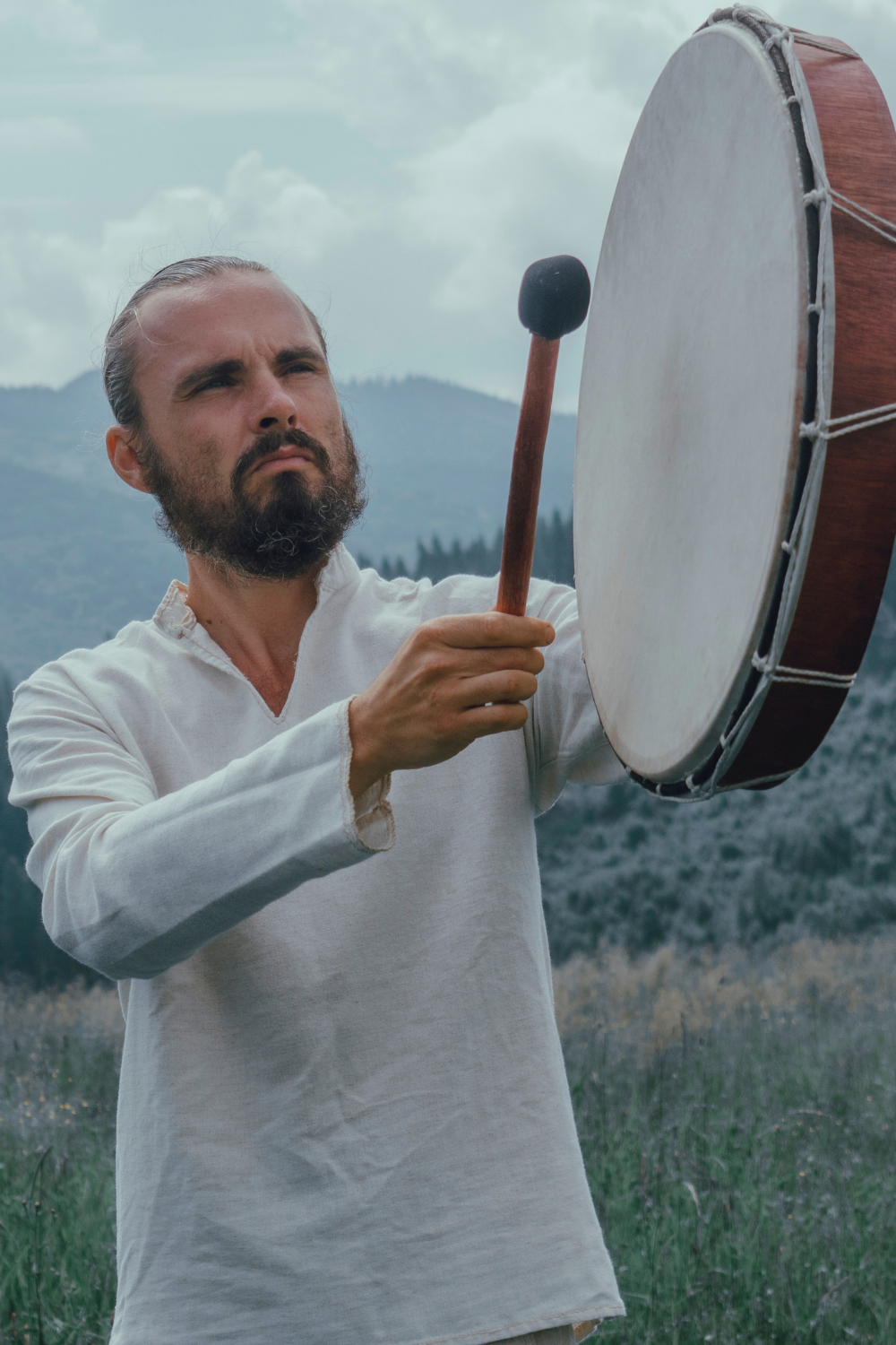 male shaman witch drumming